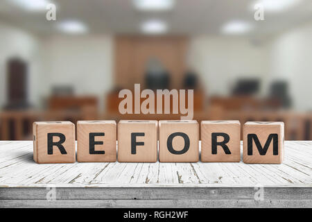 Reform sign on a desk with a blurry background of a court room Stock Photo