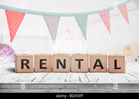 Rental sign with flags hanging over a wooden desk in a bright room Stock Photo