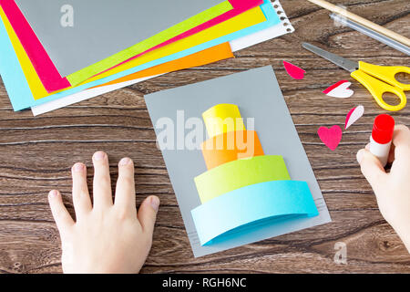 The child cuts out Greeting card with birthday cake congratulation ...