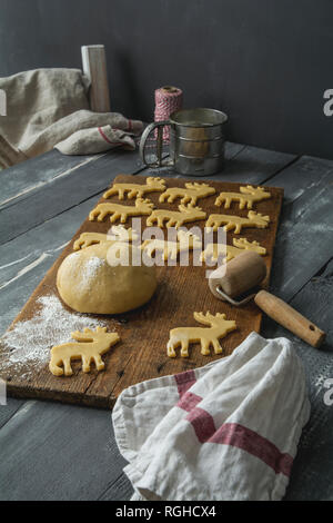 Shortcrust biscuits on wooden board, elk form, Christmas time Stock Photo