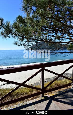 Boardwalk To Beach With Bright Sun And Blue Sky Stock Photo