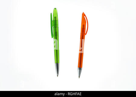 green and orange plastic ballpoint pen isolated on white background Stock Photo