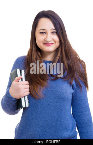 Smiling young woman student, teacher or business lady holding books looking to camera isolated over white background. Education concept. Stock Photo