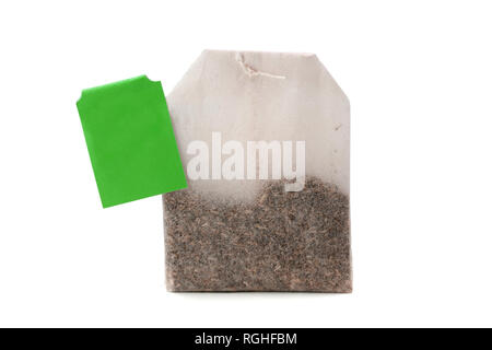 Teabag with green label isolated on white background Stock Photo