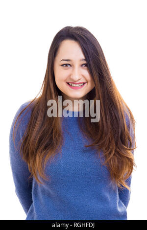 Beautiful young woman student portrait natural smile looking to camera holding hands behind back isolated over white background. Stock Photo