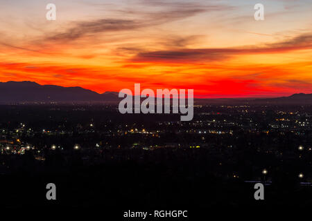 Dramatic predawn view of San Fernando Valley neighborhoods and the San Gabriel Mountains in the city of Los Angeles, California.