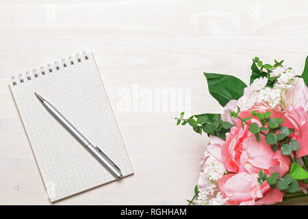 Flower with open blank note book and ink pen Stock Photo