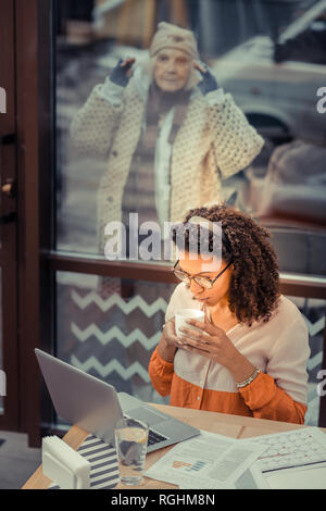 Nice afro American woman doing her work Stock Photo