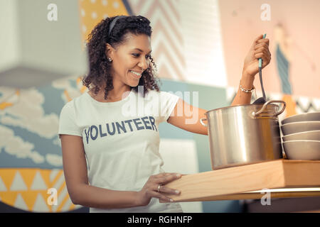 Delighted happy woman cooking in the kitchen Stock Photo