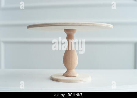 Empty wooden stand for cake isolated on white background Stock Photo