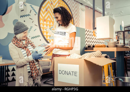 Positive afro American woman giving a nice gift Stock Photo