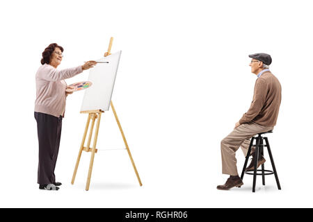 Full length shot of an elderly woman drawing a portrait of senior man on a canvas isolated on white background Stock Photo