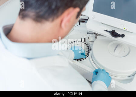 Doctor or lab technician analyzing blood Stock Photo