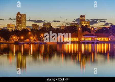 City Park at Dusk - A summer evening view of Ferril Lake in Denver City Park, with city skyline in background, at east-side of Downtown Denver, CO, US. Stock Photo