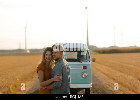 Affectionate young couple at camper van in rural landscape Stock Photo ...