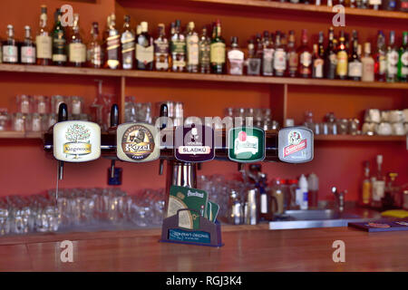 Beer taps in Prague bar with glasses and spirit bottles in background Stock Photo