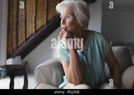 Senior woman relaxing in living room Stock Photo
