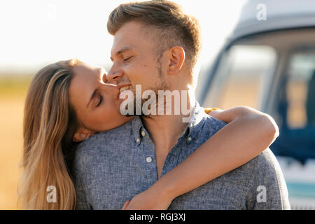 Happy affectionate young couple at camper van in rural landscape Stock ...