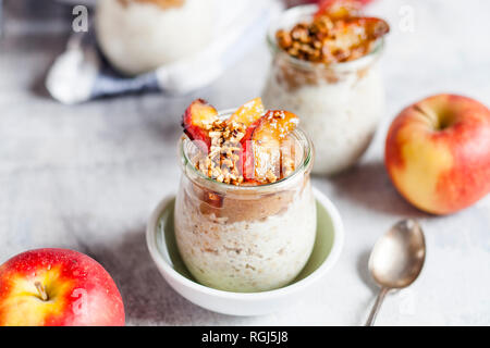 Apple pie overnight oats with caramelized apples and hazelnuts Stock Photo