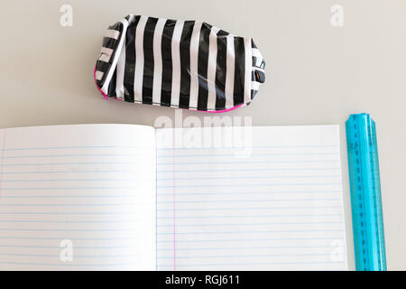 Notebook, ruler and pencil case on the desk in school Stock Photo