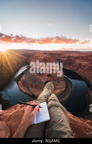 USA, Arizona, Colorado River, Horseshoe Bend, young man on viewpoint, painting Stock Photo