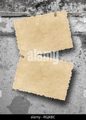 Two blank old vintage postcard frames against gray concrete wall background Stock Photo