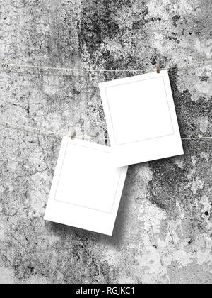 Two blank square instant photo frames against gray concrete wall background Stock Photo