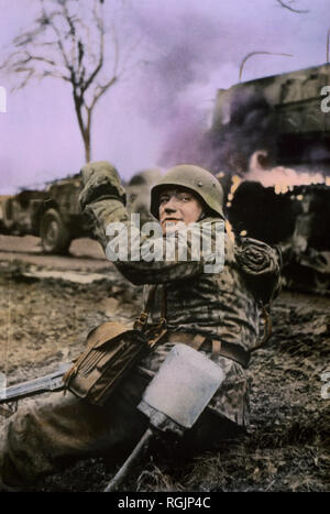 German Soldier Waving Members of his Unit Forward, Ardennes-Alsace Campaign, Battle of the Bulge, 1945 Stock Photo