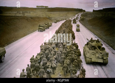 Armored Troops Moving to the Front as Prisoners are Marched along Autobahn to the Rear, Central Europe Campaign, Western Allied Invasion of Germany, 1945 Stock Photo