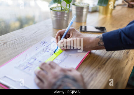 Close-up of architect working on construction plan Stock Photo
