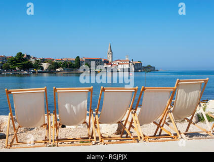 Croatia, Istria, Porec, Old town, Euphrasian Basilica, beach loungers in the foreground Stock Photo