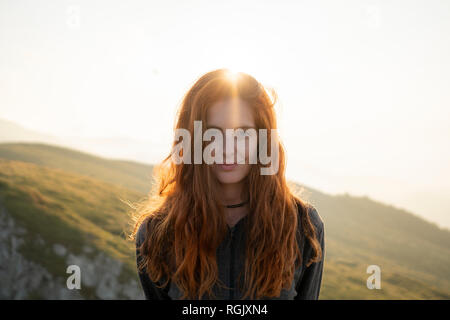 Portrait of smiling red-haired woman Stock Photo