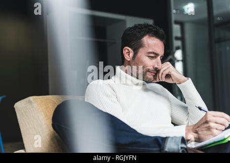 Businessman working relaxed in his office Stock Photo