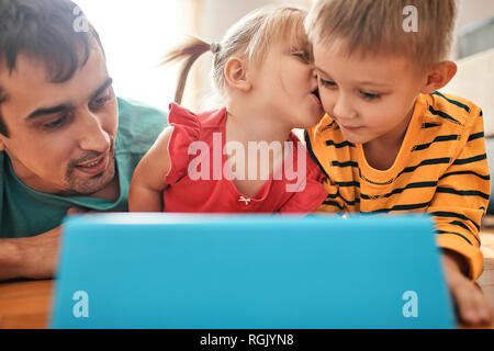 Father and his children using digital tablet at home Stock Photo
