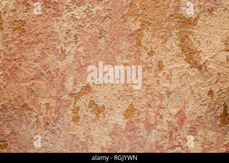Old grunge weathered cracked plastered wall closeup as background Stock Photo