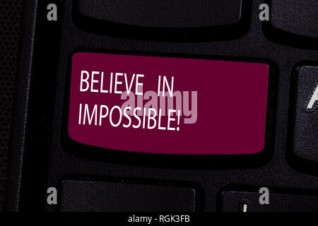 Handwriting text Believe In Impossible. Concept meaning Never give up hope that something amazing will happen Keyboard key Intention to create compute Stock Photo