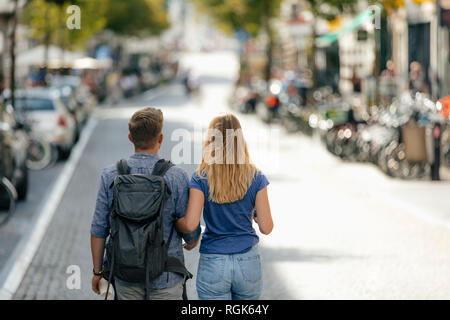 Netherlands, Maastricht, rear view of young couple walking the city Stock Photo