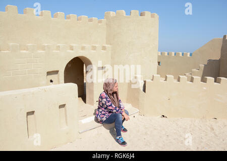 Portrait of a young woman in front of monument building at beach Stock Photo