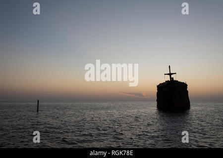 The greek ship wreckage in kish island after sunset Stock Photo