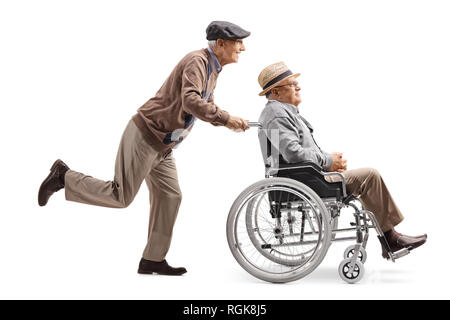 Full length profile shot of an elderly man pushing a man in a wheelchair isolated on white background Stock Photo