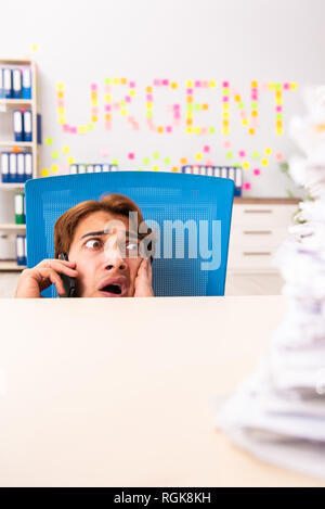 Young employee suffering from excessive work Stock Photo