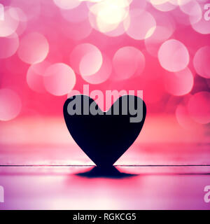 Single heart and pink bokeh abstract background Stock Photo