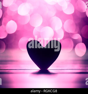 Single heart and pink bokeh abstract background Stock Photo