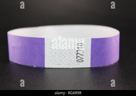 Purple violet Tyvek paper wristband for events, concerts and music festivals with tamperproof Stock Photo