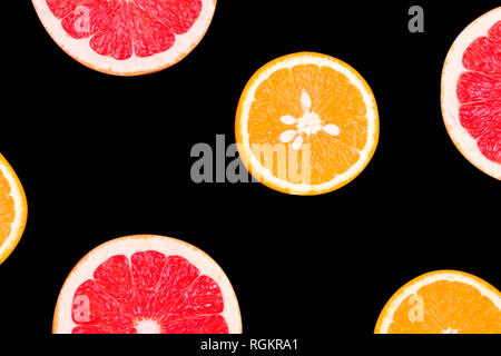 Fresh half cut grapefruit and orange isolated on black background. Close up view. Fruit concept. Healthy lifestyle concept Stock Photo