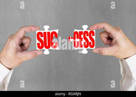 Connecting two puzzles for success concrete wall background Stock Photo