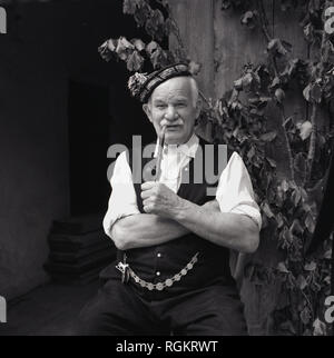 An elderly man in traditional Bavarian clothes -tourist attraction of ...