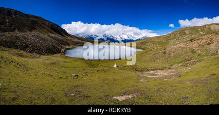 Panoramic view on Ice Lake, the snow covered summits of the Annapurna range in clouds in the distance Stock Photo