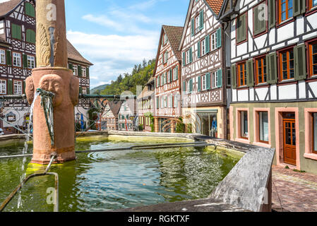 town Schiltach in the Black Forest, Germany, picturesque well at market place surrounded by half-timbered houses, historical old town Stock Photo