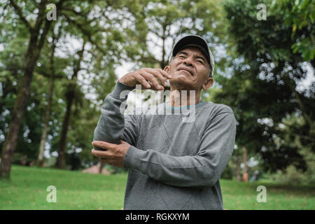 old man hold his elbow with serious pain Stock Photo
